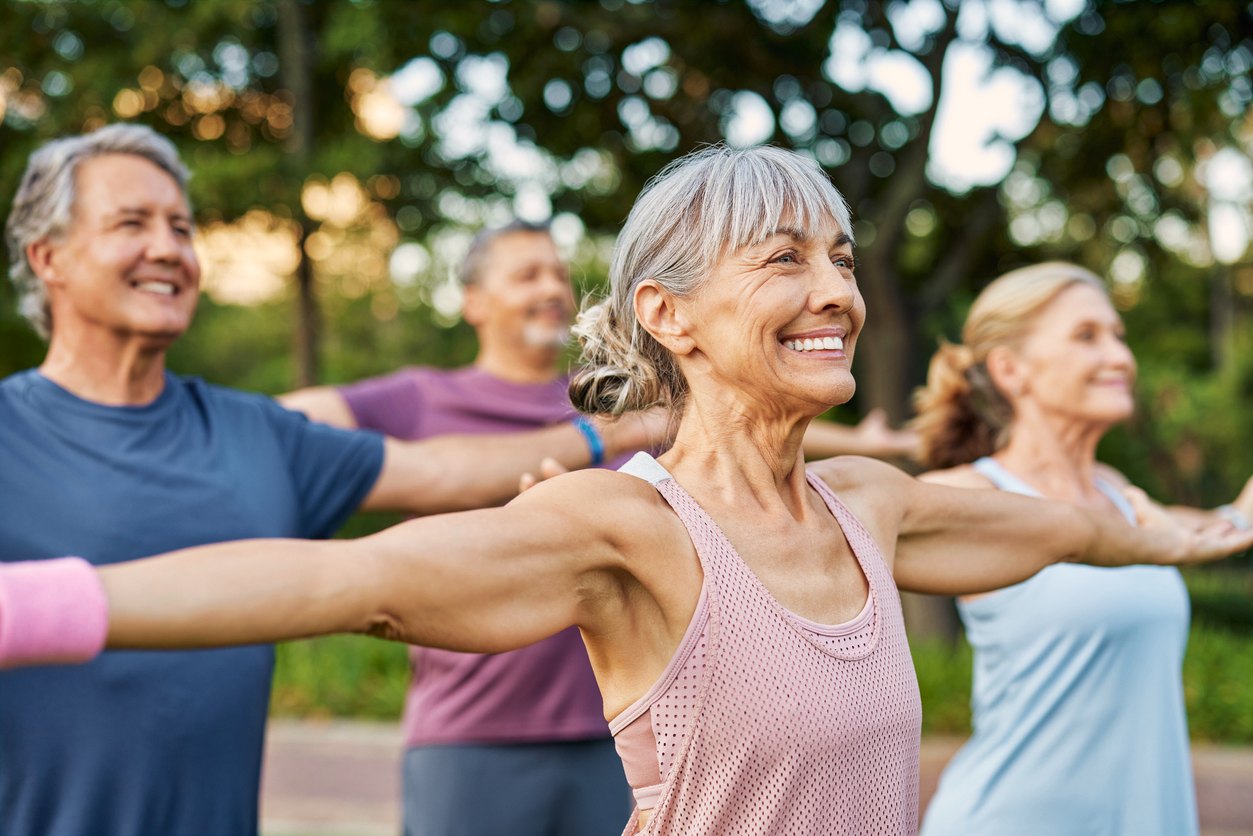 Active older adults exercising outdoors, representing independent living communities in metro Georgia